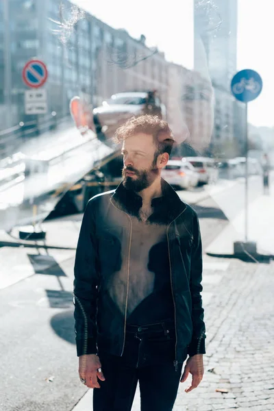 bearded man outdoor overlooking pensive