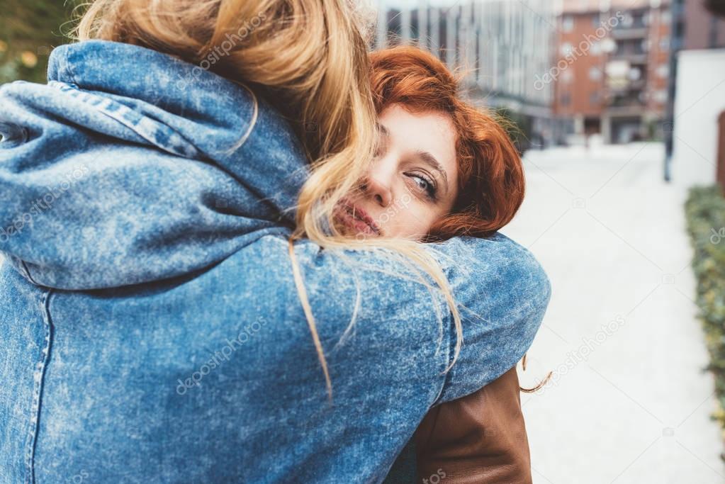 women friends hugging outdoor 