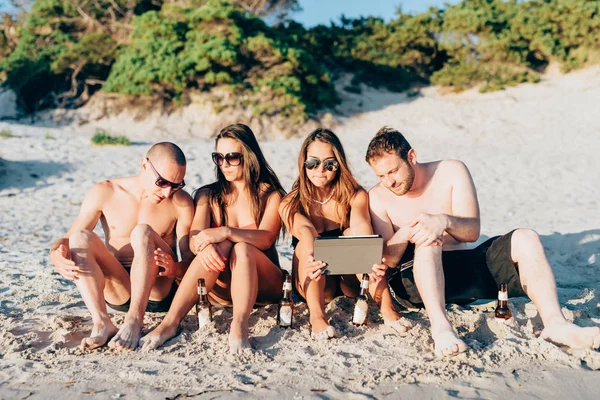 Vrienden op strand met behulp van Tablet PC — Stockfoto