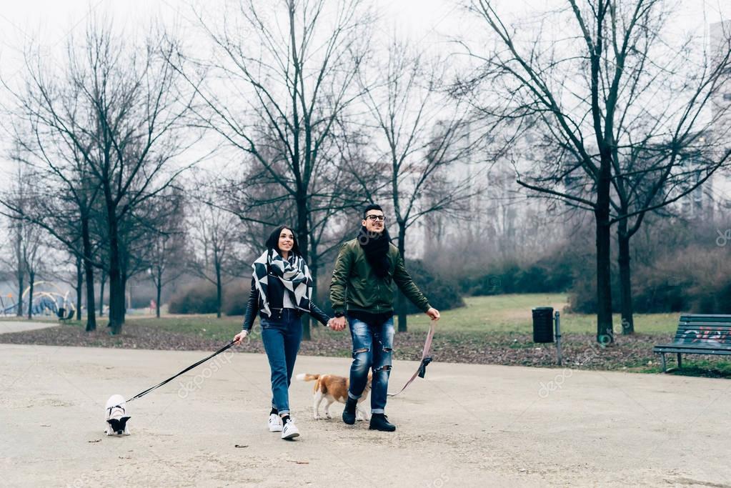 couple walking outdoor with dogs 