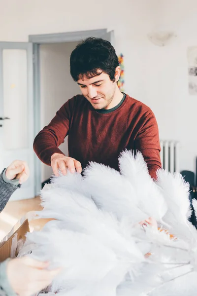 Man at home decorating christmas tree — Stock Photo, Image