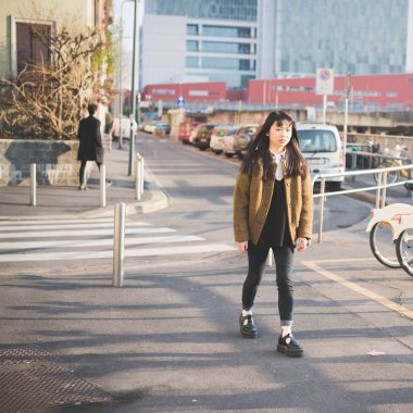 woman walking looking sideways serious 