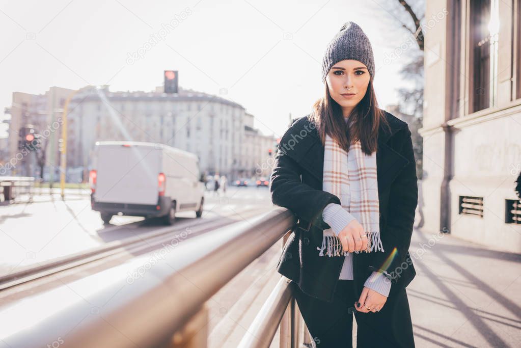 Young woman looking camera serious outdoor back light