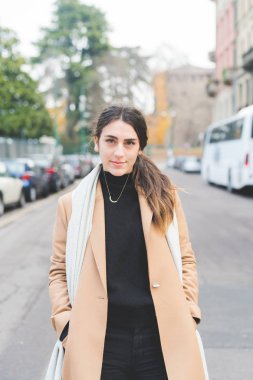 Genç bir kadın kameraya gülümsüyor. Huzur, mutluluk, pozitif bir konsept.