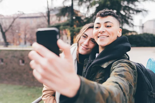 Two Women Lesbian Couple Outdoors Using Smart Phone Taking Selfie — Stock Photo, Image