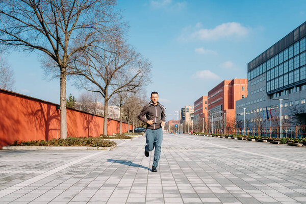 young man running outdoor training in the city - exercise, healthy lifestyle, sport concept