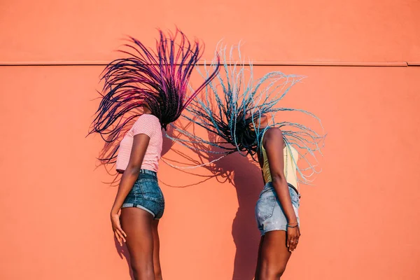 Two women sisters dancing moving hair outdoor — Stock Photo, Image