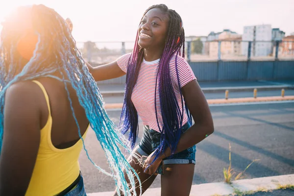 Two women sisters outdoor listening music dancing — ストック写真