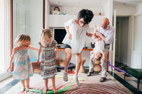 Beautiful family indoor playing with balloon toys — 스톡 사진