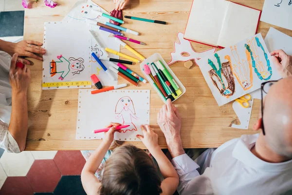 Overhead view family indoor drawing with coloured pencil — 스톡 사진