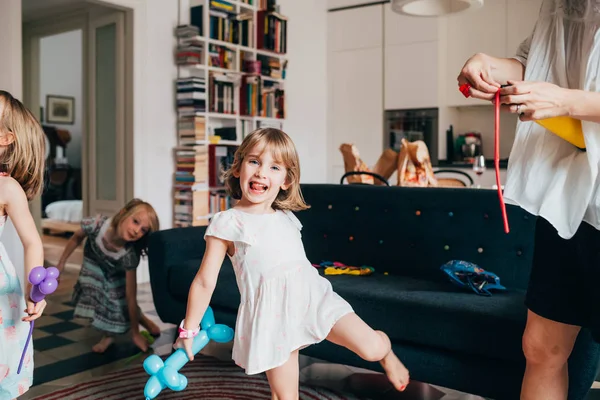 Young beautiful female child indoor at home playing with baloon — 스톡 사진