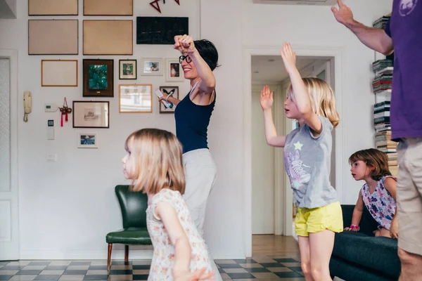 Family dancing together indoor playing videogame