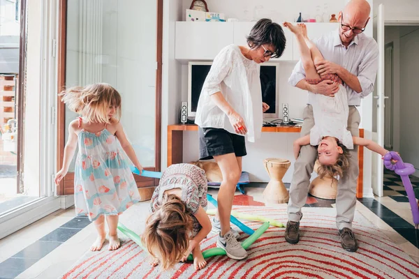 Beautiful family indoor playing with balloon toys — 스톡 사진