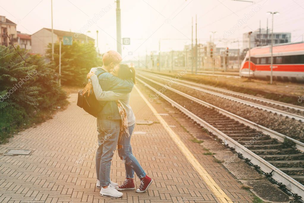 Two young women hugging train platform - farewell, saying goodbye, sad concept