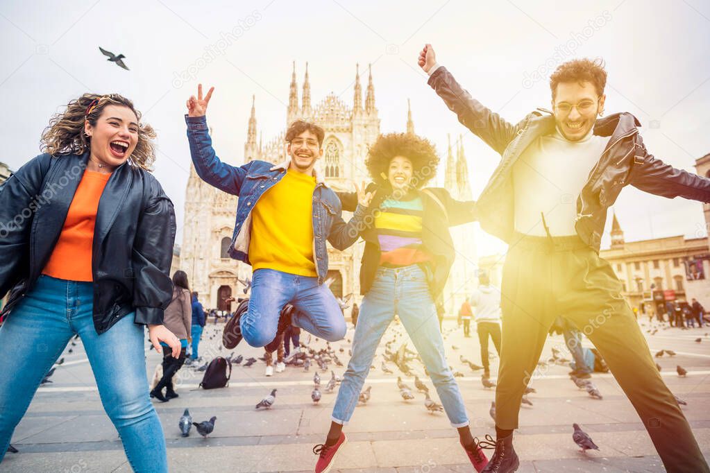 Group of for multiethnic people friends jumping in front of milan cathedral - celebration, freedom, victory concept