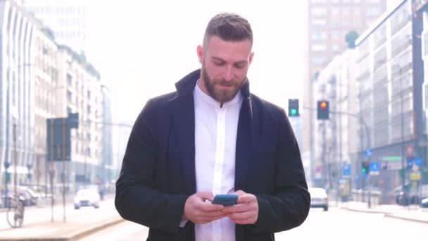 Slow Motion Young Handsome Caucasian Bearded Man Outdoor Holding Smartphone — Stock Video