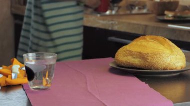 Kadın masada bir bardak vejetaryen fındık kremi servis ediyor.