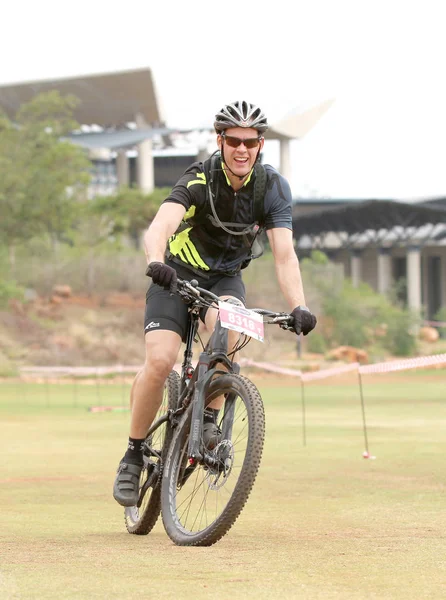 Happy middle aged man riding to the finish line at Mountain Bike — Stock Photo, Image