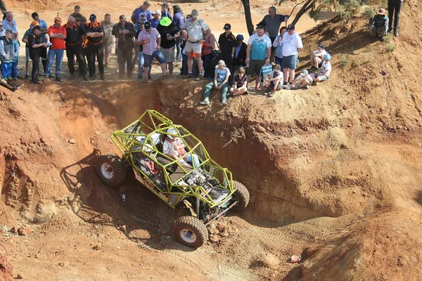 Bright green car negotiating obstacles in dugout. Top view. — Stock Photo, Image