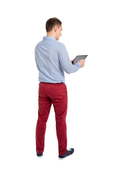 Back view of standing young men and using a tablet. — Stock Photo, Image