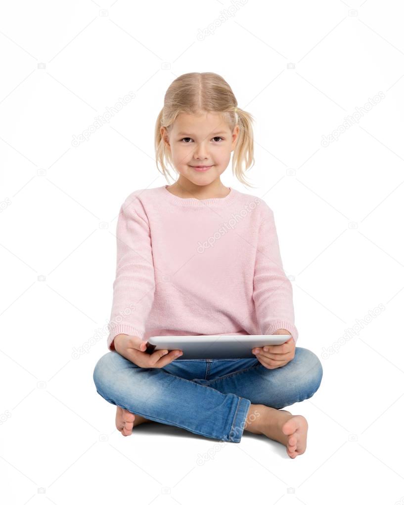Young cheerful girl sitting with digital tablet