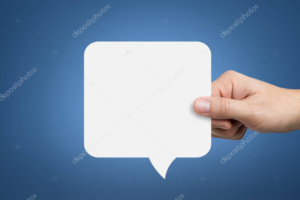 Hand holding an empty speech bubble