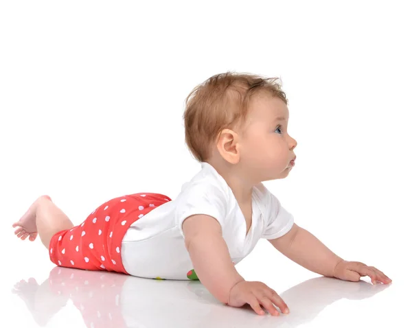 Four month Infant child baby girl lying in red pants on a floor — Stock Photo, Image