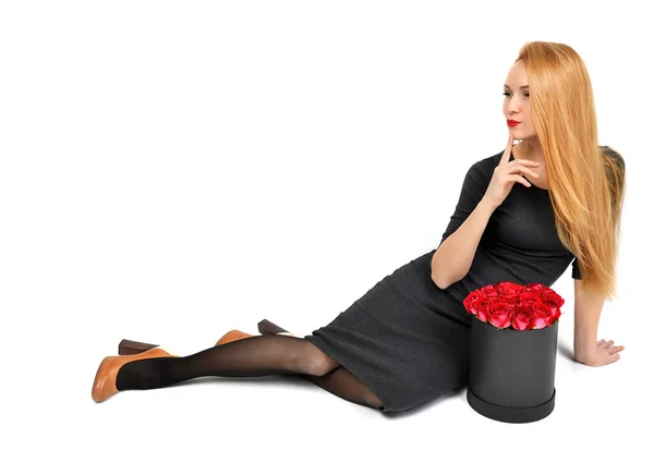 Beautiful fashion woman sitting with a bouquet of roses in prett — Stock Photo, Image