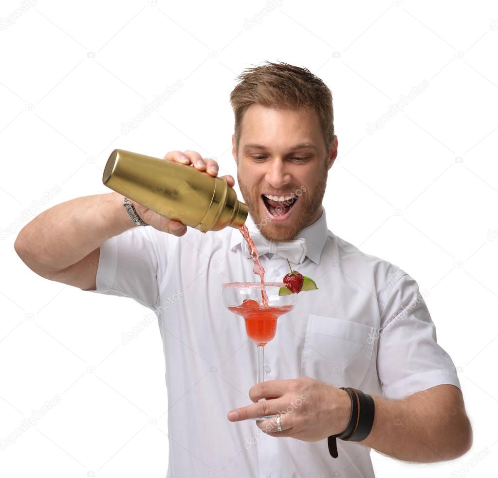 Bartender men is making red margarita cocktail with strawberry a