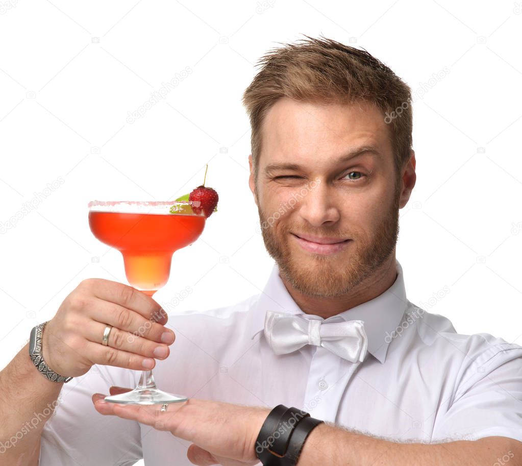 Bartender men with red margarita cocktail with strawberry and li