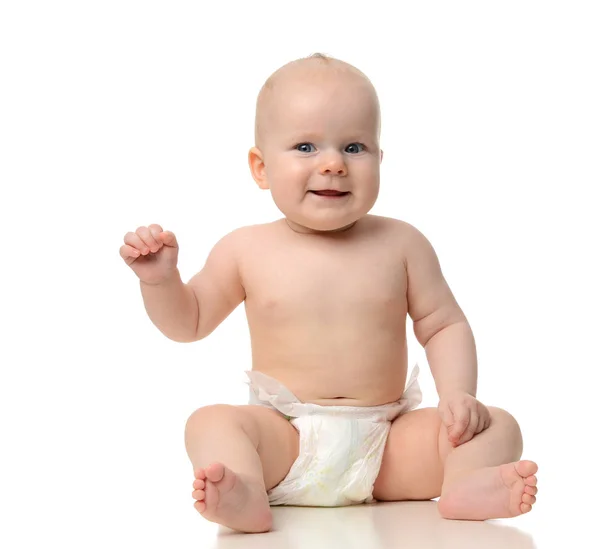 Infant child baby girl toddler sitting naked in diaper looking a — Stock Photo, Image