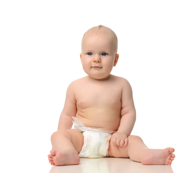 Infant child baby girl toddler sitting naked in diaper looking a — Stock Photo, Image