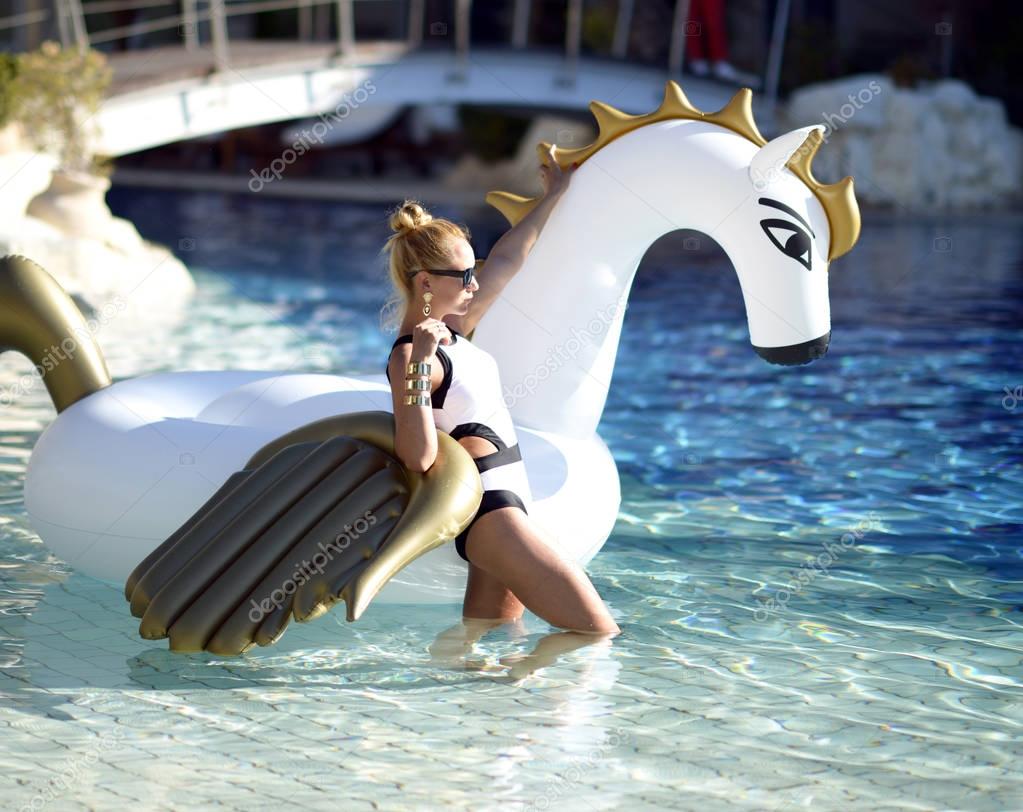 pretty fashion woman relaxing in luxury swimming pool resort hot