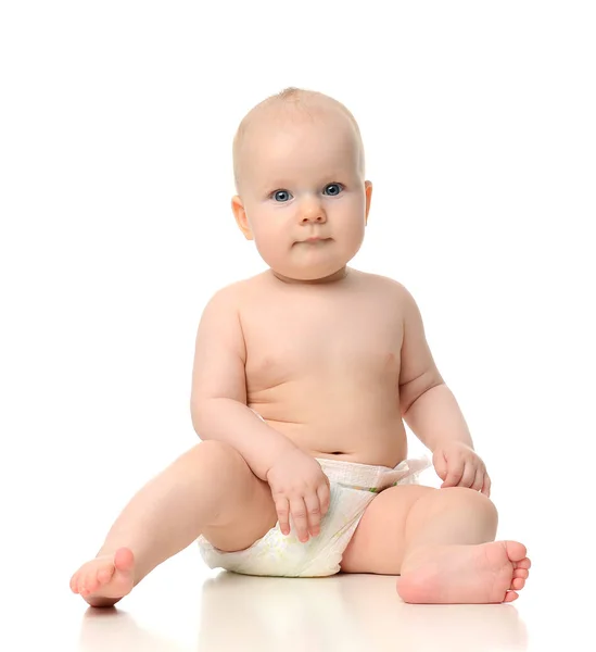 Infant child baby girl toddler sitting naked in diaper looking a — Stock Photo, Image