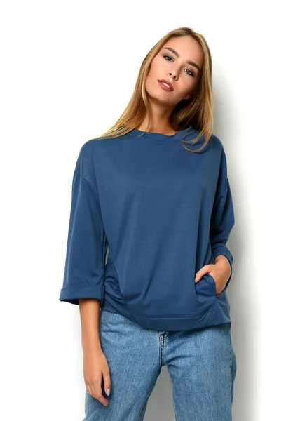 Giovane felice bella donna in posa in nuova moda jeans blu e pullover — Foto Stock