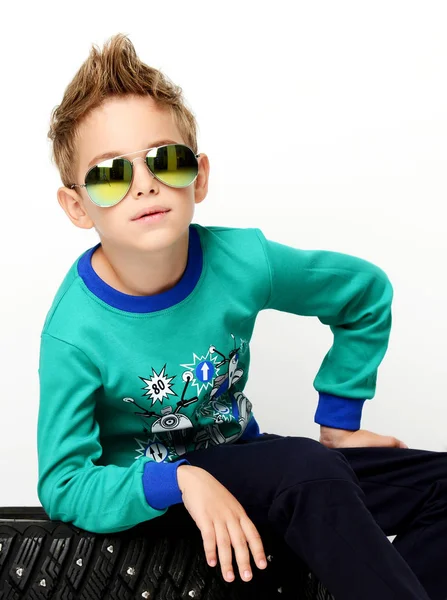 Szczęśliwy młody chłopak siedzi w zielony sweter w okulary przeciwsłoneczne aviator — Zdjęcie stockowe