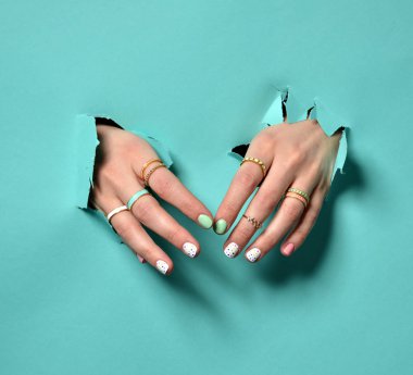 Sarı Pembe Beyaz desen tırnak cilası ile güzel kadın el 