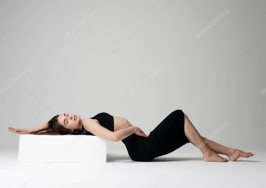 Slim beautiful brunette woman lying posing on a floor in sexy underwear bra  