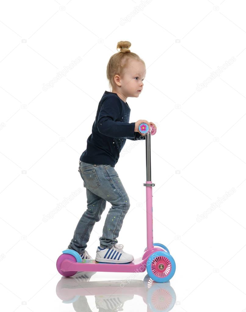 child toddler girl learning to ride and balance on push three Wheel Adjustable Height Scooter