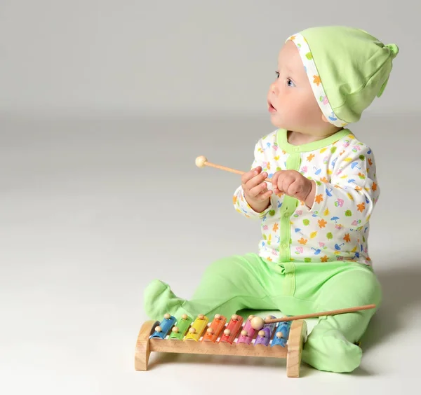 Portrait of Infant child baby boy kid toddler sitting in light green body and play with xylophone toy — Stock Photo, Image