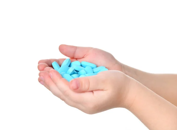 Young child baby kid hands hold blue pain killer tablet of medicine — Stock Photo, Image