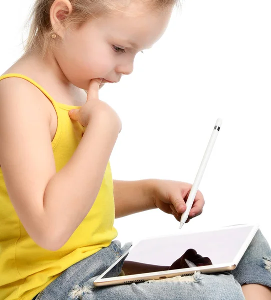 Young girl kid sitting reading learning drawing on digital tablet touch screen pad with pencil — Stock Photo, Image
