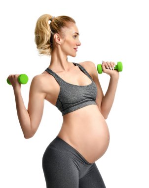 Hamile kadının spor germe yapması yeşil ağırlık egzersizleri. Hamilelik annelik beklentisi sağlıklı yaşam ve kilo kontrolü kavramı