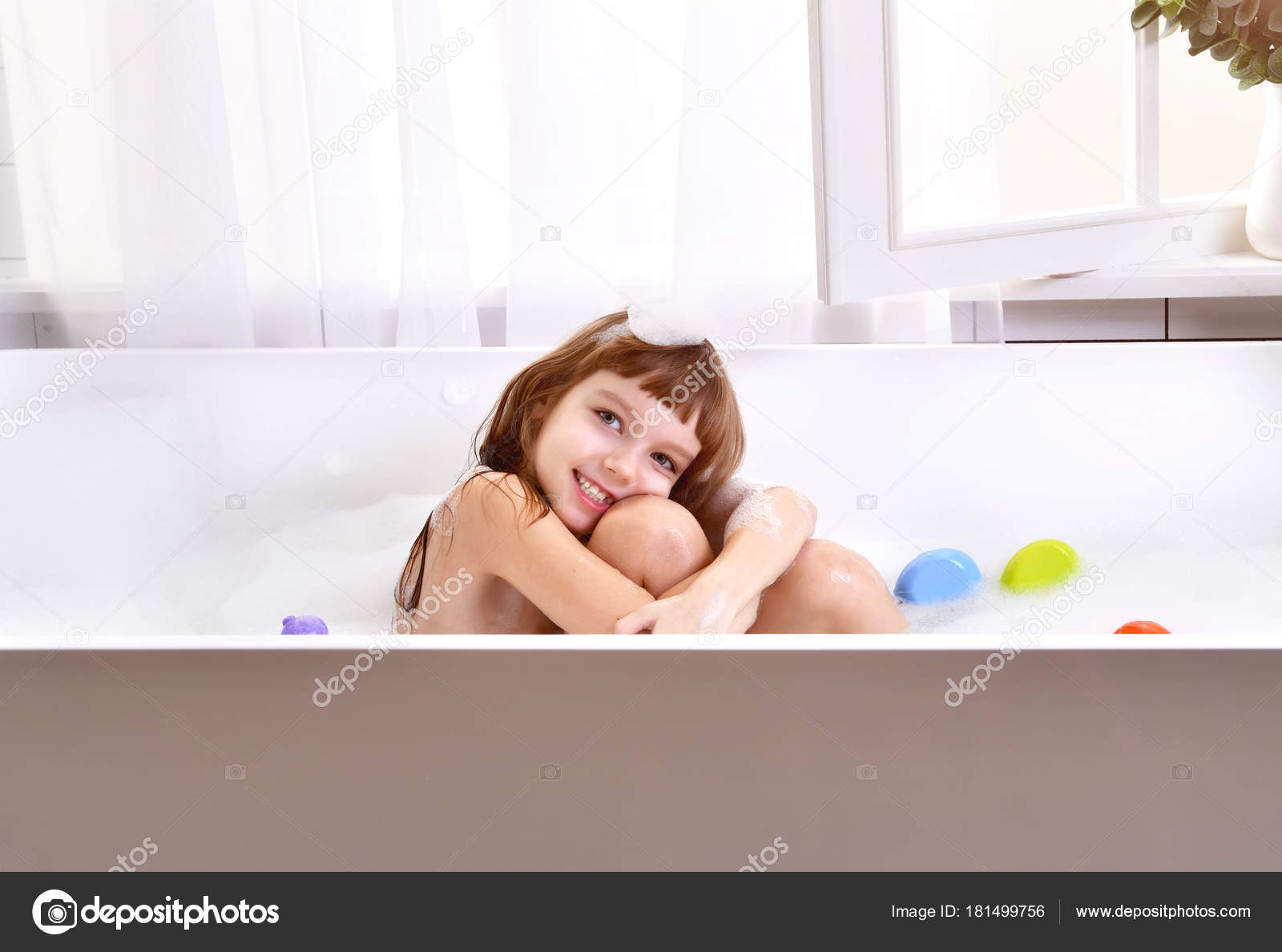 Happy Little Baby Girl Kid Sitting In Bath Tub In The