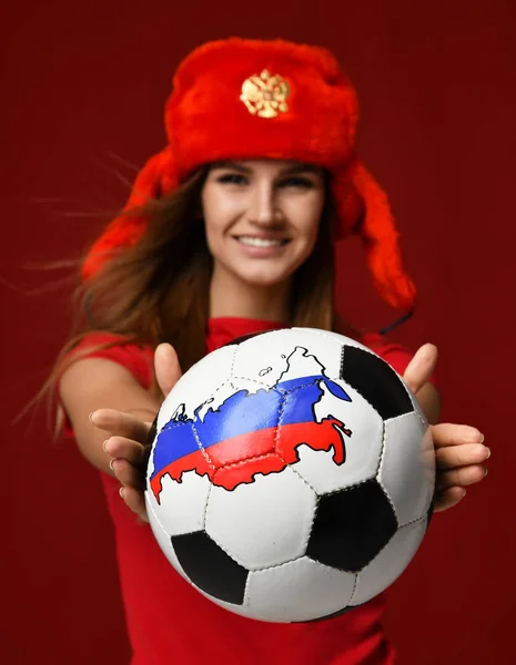 Russian style fan sport woman player in red uniform give soccer ball celebrating happy smiling — Stock Photo, Image