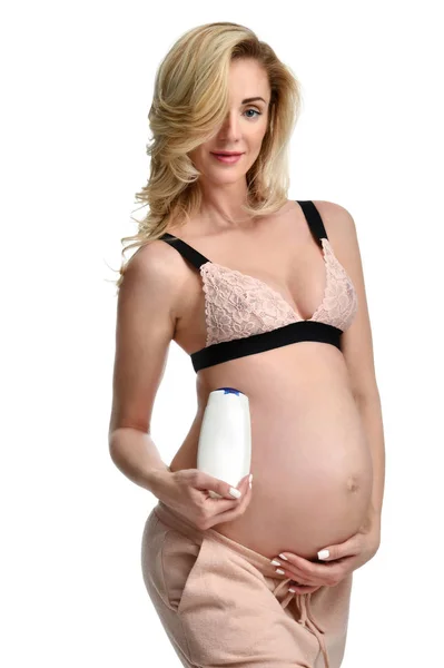 Έγκυος γυναίκα με λοσιόν, κρέμα για την κοιλιά — Φωτογραφία Αρχείου