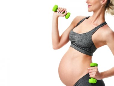 Hamile kadının spor germe yapması yeşil ağırlık egzersizleri. Hamilelik annelik beklentisi sağlıklı yaşam ve kilo kontrolü kavramı