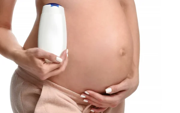 Pregnant woman with lotion cream for her belly — Stock Photo, Image