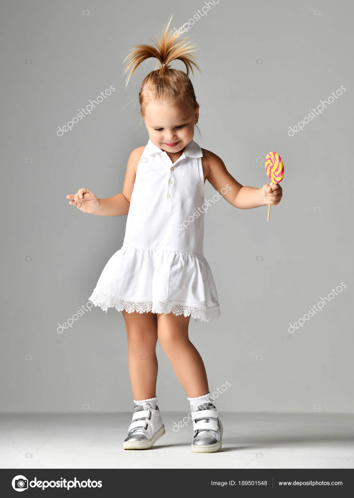 Young Pretty Toddler Girl Kid With Big Sweet Lollypop Candy In