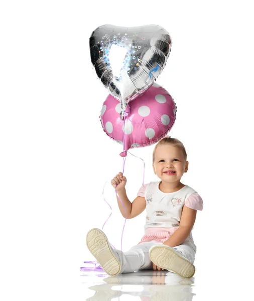 Two years girl toddler kid with balloons sitting celebrating isolated on white — Stock Photo, Image